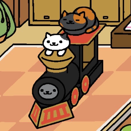 Bandit sleeps on top of the cardboard train as a "cat loaf", Lexy looks out the smokestack with their paws out. Shadow looks out from where the train's engine would be.