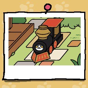 Gabriel is a cat with a black upper face and a white lower face. The white part is shaped like a triangle. Gabriel has yellow eyes. The cat looks out of the cardboard train where the engine should be.