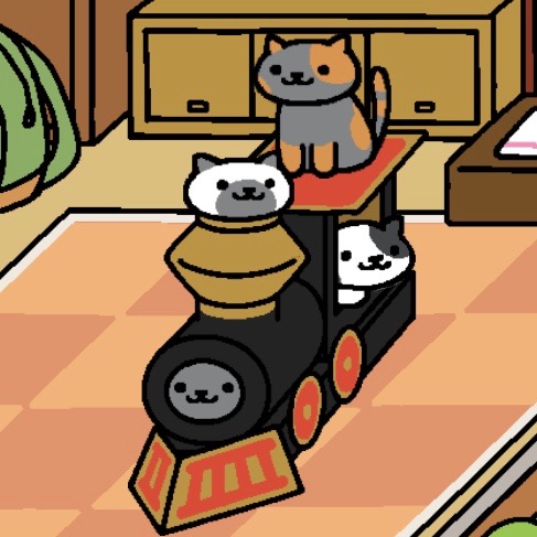 Spooky is sitting up on the top of the cardboard train. Marshmallow has stuck their head out of the smokestack. Dottie looks out of the train's window. Shadow is still looking out from where the train's engine should be.