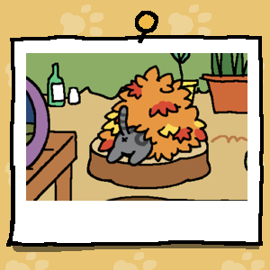 The backside of a grey cat with black stripes sticks out of a pile of leaves.