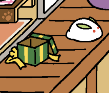 A green gift box is empty. The lid of the box is tipped on the side of the box. The gold bow is on the floor next to it.