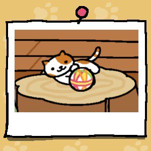 A white cat with orange spots on its face, ears, back, and orange stripes on its tail plays with a fabric ball.