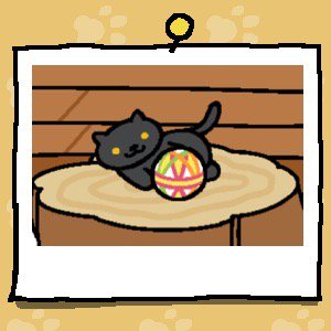 A black cat with yellow eyes plays with a fabric ball.