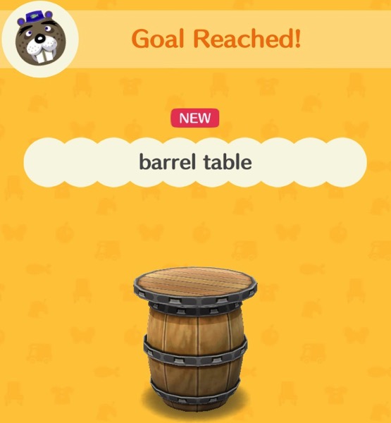 A table that is made out of a barrel. It has metal rings around the barrel to hold it together. On top is a round table top with a metal ring around it.
