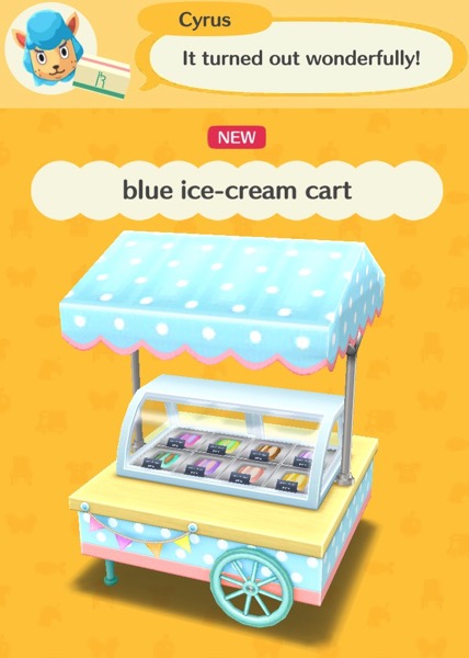 A cart that has a refrigerated case with ice cream inside it. A blue canopy with white dots is over it. One side of the cart has wheels, the other small legs.