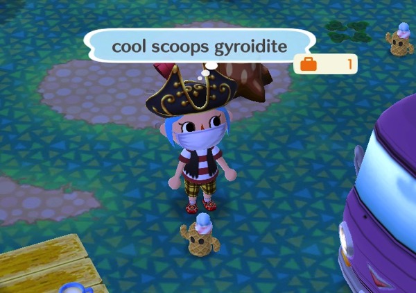 My Pocket Camp character is wearing a pirate captain's hat, a pirates tee and vest, and other items. At their feet is a cool scoops gyordite. It is patterned like an ice cream cone, and has two scoops of ice cream on top of it.