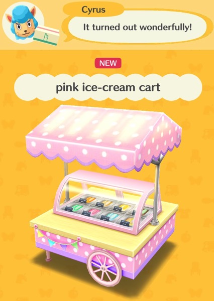 A cart with a refrigerated area that holds ice cream. Over it is a pink canopy with white spots. The back of the cart has wheels, and the front has feet.