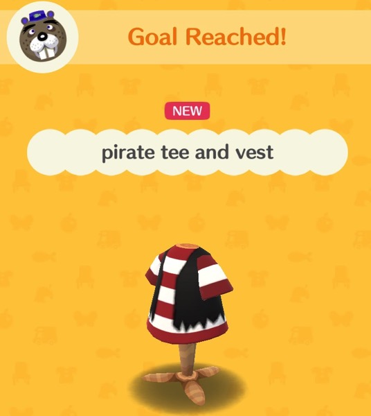 A red and white striped pirate tee shirt with a black vest over it. The ends of the black vest are tattered.