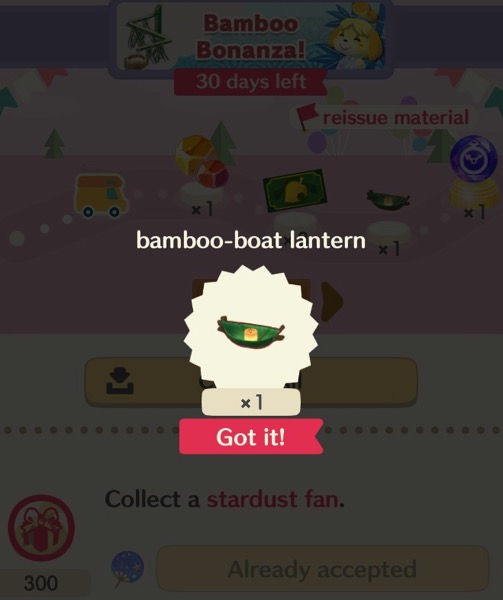 A small, green, boat made out of bamboo, is in a circle shape. The boat has a lit candle inside it.