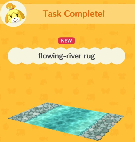 A rug that has rock-like shapes on two of its ends. In the center is part of a flowing river.