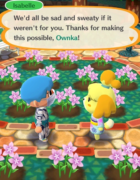 My Pocket Camp character is talking with Isabelle in the campsite garden. 