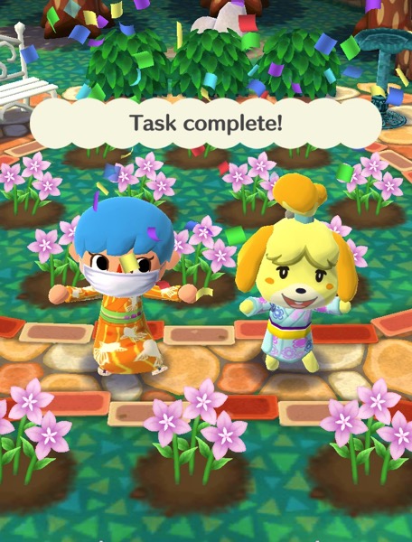 My Pocket Camp character is wearing an orange kimono that hs outlines of fish on it. Isabelle is next to them with a kimono-like outfit.