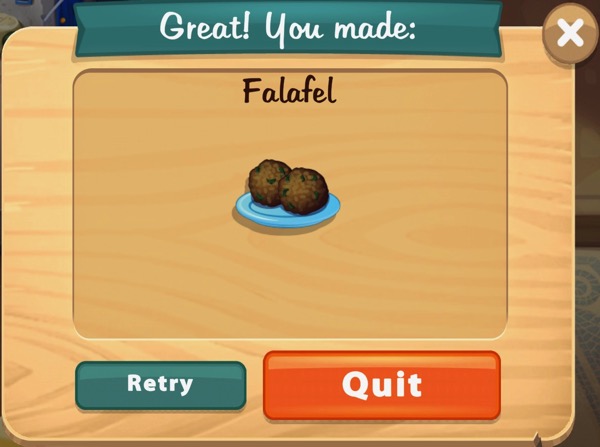 Two balls of Falafel are sitting on a light blue plate.