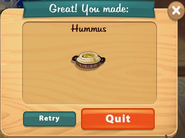 A small bowl with handles on either side holds some hummus.