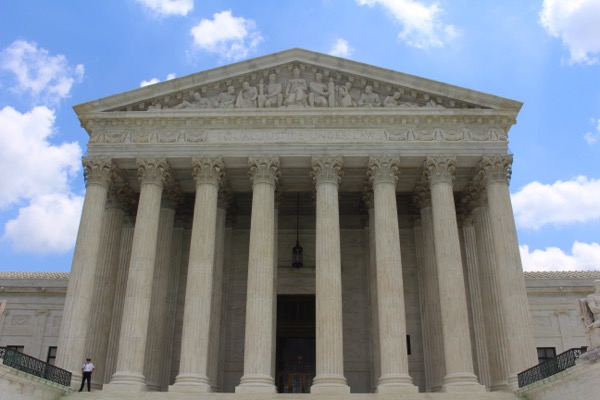 Photo of the front of the Supreme Court by Clare Anderson on Unsplash