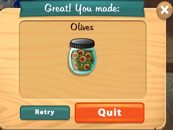 A jar of green olives, each with a red center.