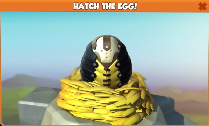 A Nightmare Dragon egg sits in a nest. At the top is a white part that resembles a skull. Most of the egg is covered with what look like leather straps. There is a yellow section in the middle that could be a vest.
