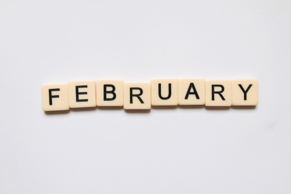 Scrabble titles spell out the word February. Photo by Glen Carrie on Unsplash