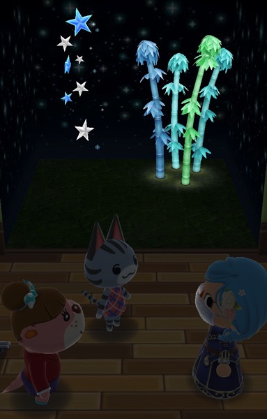 My Pocket Camp character is wearing a blue dress with gold on it, and a wig that has flowers in it. Next to them is Lottie and Lolly. In the background are two glowing items.