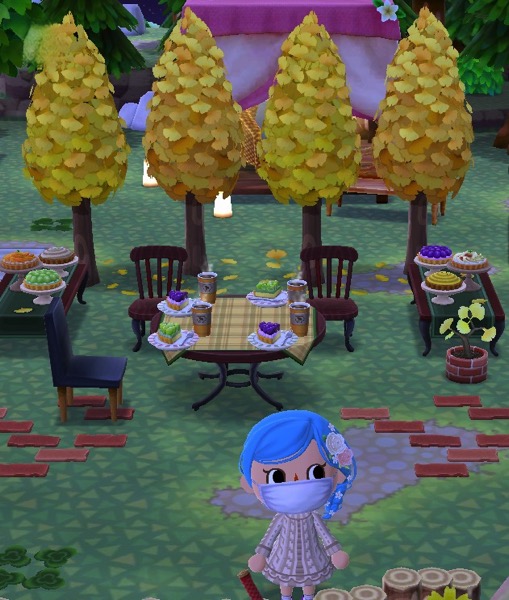 My Pocket Camp character is in front of a slightly different configuration than before. Four maidenhair trees stand in the background.