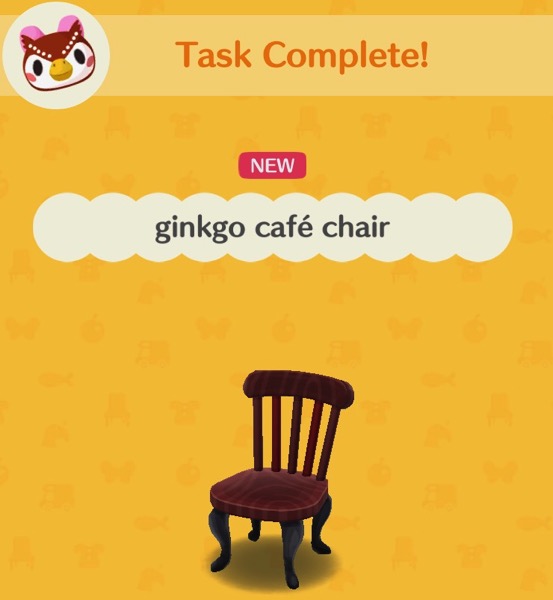 A dark brown wooden chair that you might find in a coffee shop or café.