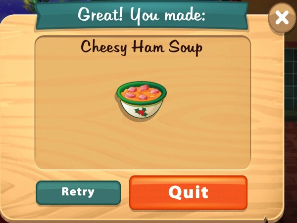 A white bowl with a holly leaf decoration on the front of it, and a green rim, holds a bowl of cheesy ham soup.