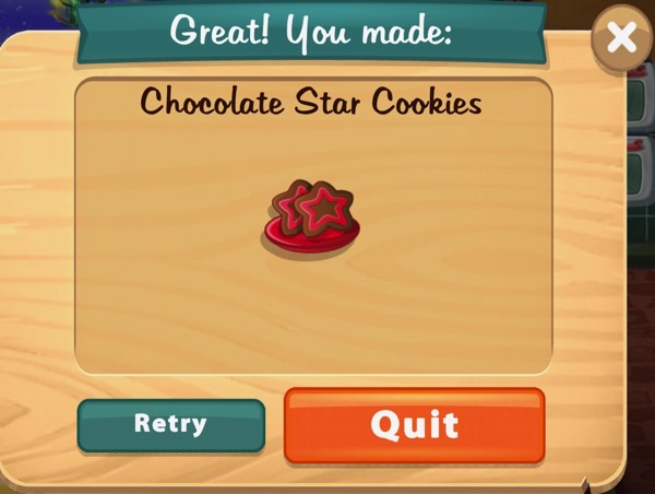 Two chocolate cookies sit on a red plate. The cookies are shaped like stars. There is a red outline of a star on the front of each cookie.