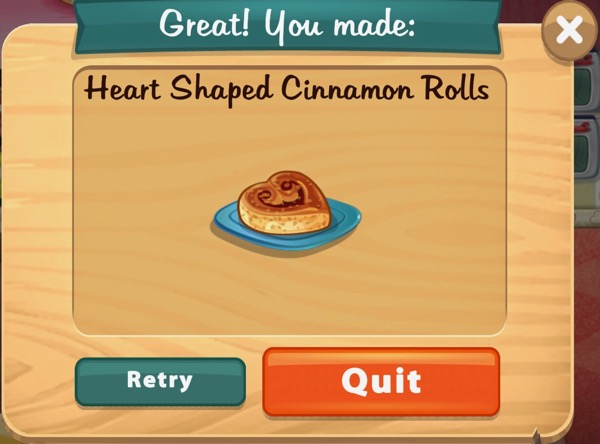 A heart shaped cinnamon roll sits on top of a square blue plate.