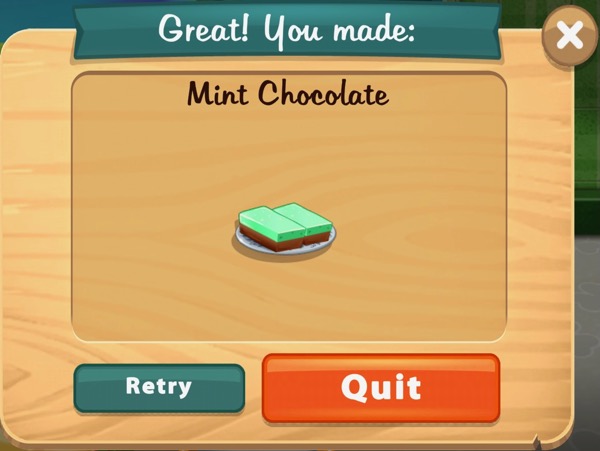 Two mints, each with a green bright green top sitting on a rectangle of chocolate, are on a white plate.