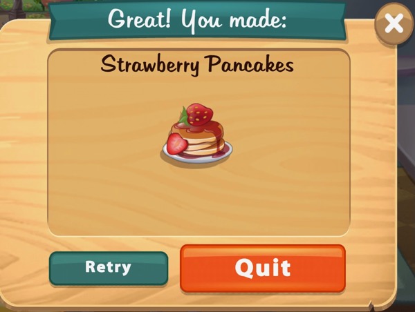 A stack of pancakes, with strawberry syrup, and a strawberry on top, sits on a white plate. There is also a cut strawberry on the side of the pancake stack.