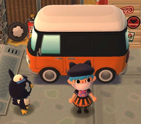 My Pocket Camp character is standing next to a blackbird who is a mechanic. Behind them is a Volkswagen bus-like camper. The top is white, the middle is black, and the bottom is orange. Halloween colors!