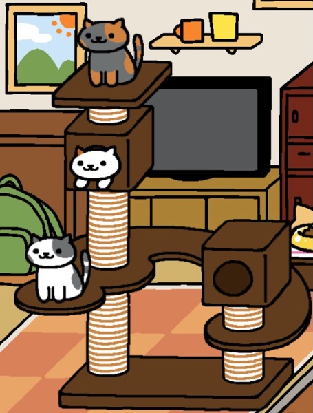 Spooky is a grey cat with light orange spots and strips. Spooky sits up on the top of the highest box in the Cat Metropolis. Inside that box is a Caramel, a white cat with Carmel colored spots. Caramel looks out of the box and sticks out their paws. Below Caramel is Willow, a white cat with grey spots on their ears, face, back, and tail. All three cats look at the viewer. All three cats are on the same side of the Cat Metropolis, giving it an unbalanced look.