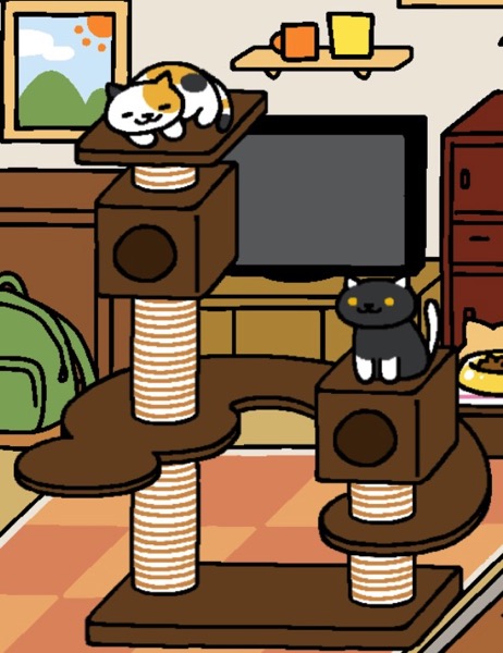 A calico cat named Sunny is white with orange and black spots and stripes. Sunny sleeps in a crescent shape on the highest part of the Cat Metropolis. Socks is a black cat with white paws, tail, and ears sits on top of one of the boxes on the Cat Metropolis. Socks has yellow eyes.