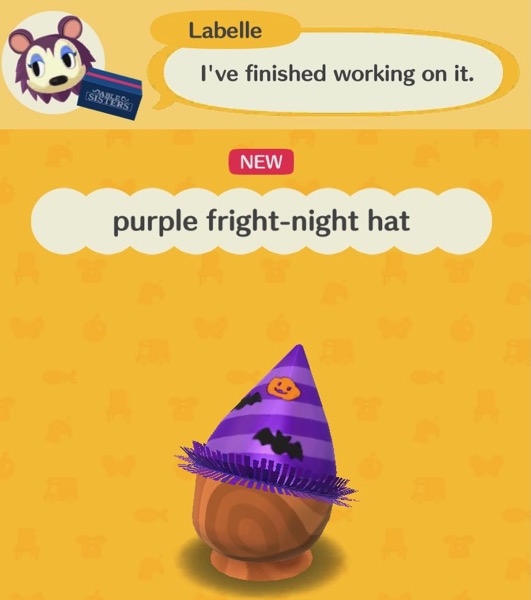 The purple fright-night hat has a pointed shape. Light and dark purple stripes, at an angle, cover the hat. The hat has a pumpkin with a face on it, and two flying bats. The hat has a purple decoration going around the part nearest the wearer's face. The decoration looks itchy.