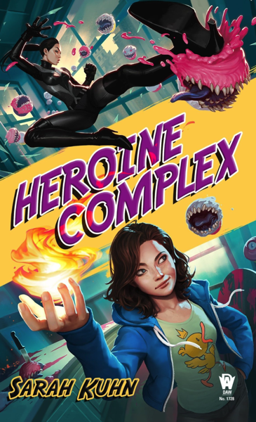 The top of the book cover shows a woman wearing an all black, tight fitting superhero outfit. She is kicking a pink cupcake that has teeth. More cupcakes with teeth are behind her. The center of the book cover has a bright yellow, thick, diagonal line. It says "Heroine Complex" (the book's title) in purple font. Below the title, there is a woman who is wearing a blue unzipped hoodie, and a t-short with a cartoon duck on it. She holds up one of her hands - which has a fireball floating just above it.