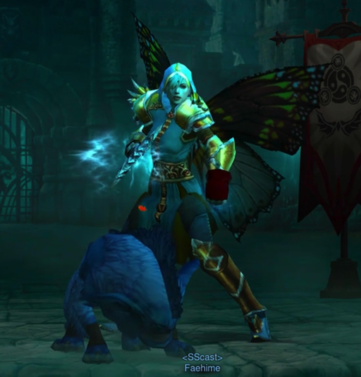 A Monk is wearing some pieces from the "Tyrael" set. She carries a weapon with spikes on it in one hand. Her other hand is inside a gauntlet She has butterfly wings on her back. In front of her is a blue demon pug dog that might be undead. The dog is sniffing the ground.