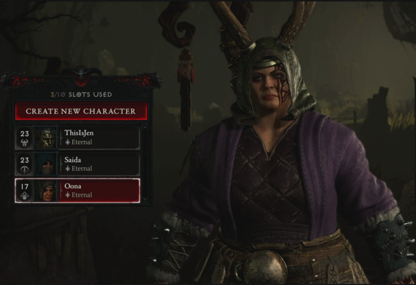 A Diablo IV Druid looks out at the viewer. She is wearing a hood with antlers on the top of it. The Druid has a staff on her back that has a curled end which a decorative object dangles from. She is waring a purple jacket over a brown, quilted, leather shirt. Her gloves are also made of leather. She wears a belt with things attached to it.