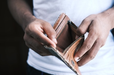 Man opening an empty leather wallet by Towfiqu barbhuyia on Unsplash 