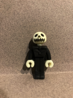 Day fourteen gave me the best looking Jack Skellington of all the plastic figures so far. He is wearing all black clothing. His hands look like LEGO hands, and his head has the best face of all the plastic figures (so far).