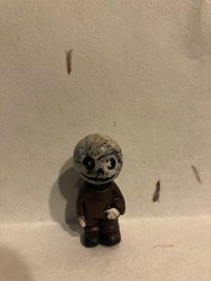 Day 11 is Jack Skellington! His face is a mixture of white and grey. His eyes, (lack of) nose and mouth look good enough for this hard plastic figure. Jack is wearing dark brown clothing, and his hands are white.