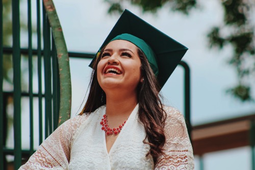 Photo of a smiling woman wearing a graduation cap by Juan Ramos on Unsplash