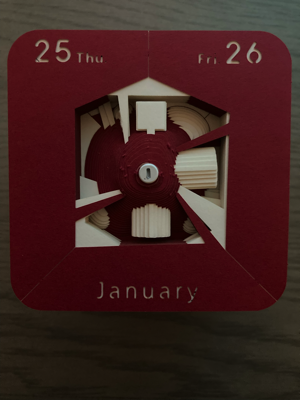 A red calendar piece for January 25 and 26 shows more of the structures beneath it. 
