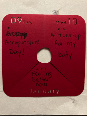 A red piece of paper has a haiku written on it: Acupuncture Day! / A tune-up for my body / Feeling better now